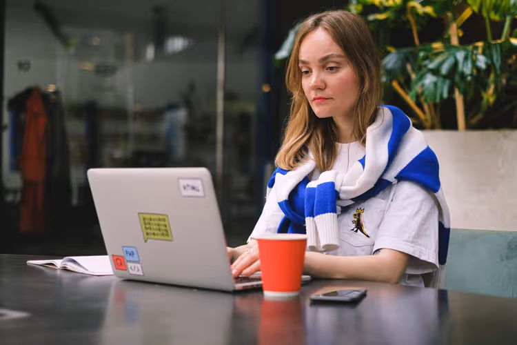 Freelancer working on a laptop in a cafe