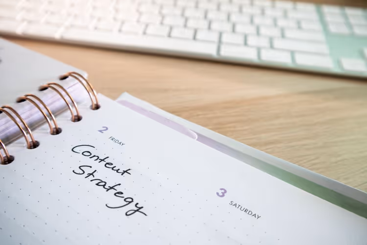 Notebook with a content plan and keyboard on the author's desk