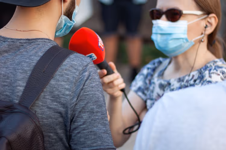 Journalist interviewing an expert during filming