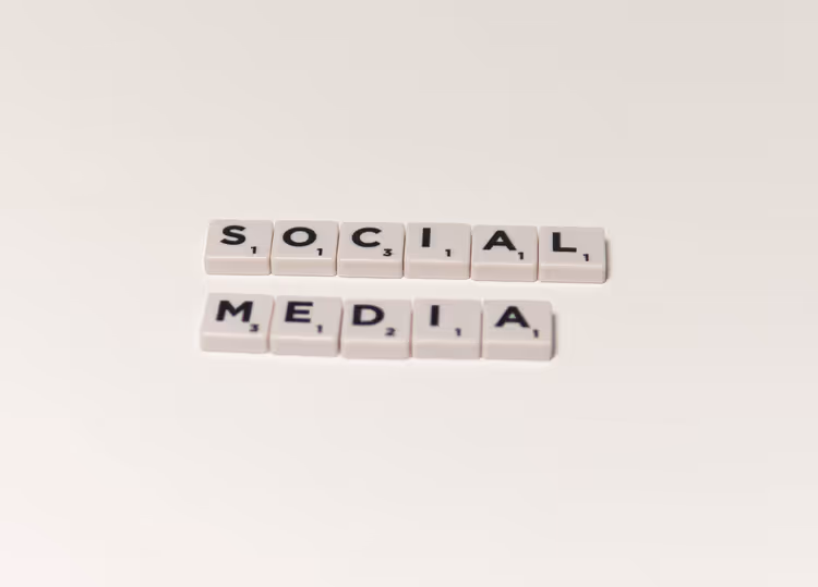 Letter tiles spelling social media on a white background