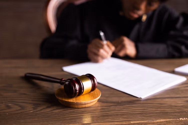 Judge signing documents at a desk