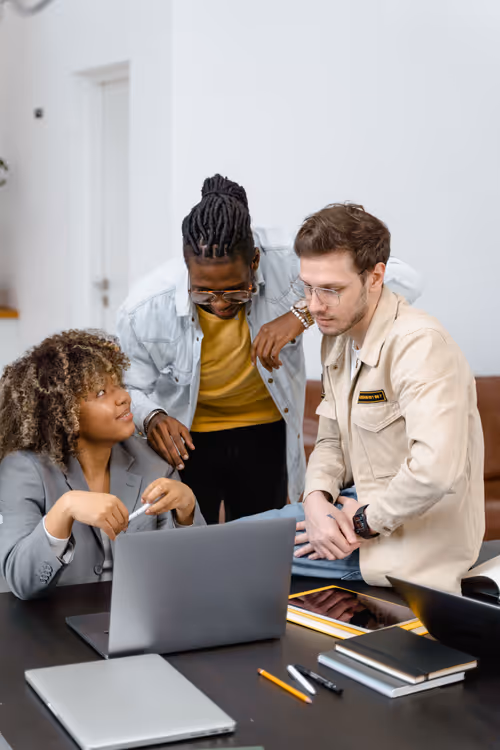 Two colleagues plan a venue outreach strategy over documents