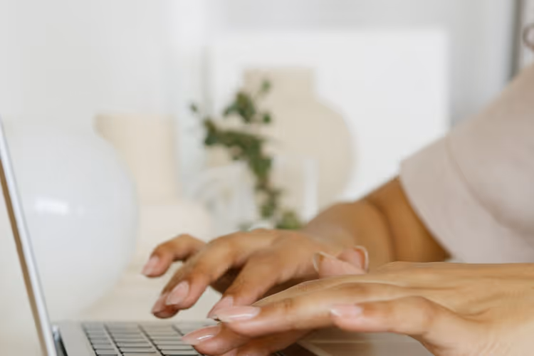Hands typing a letter to an editor on a laptop
