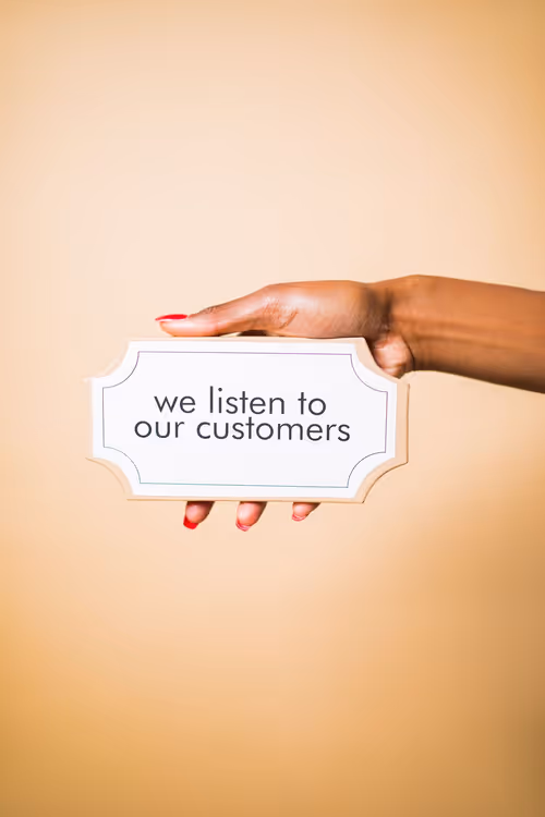 Person holding a sign about customer care