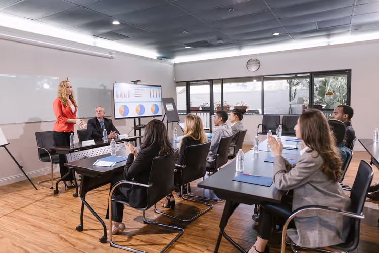 Woman speaking to an audience at a business conference