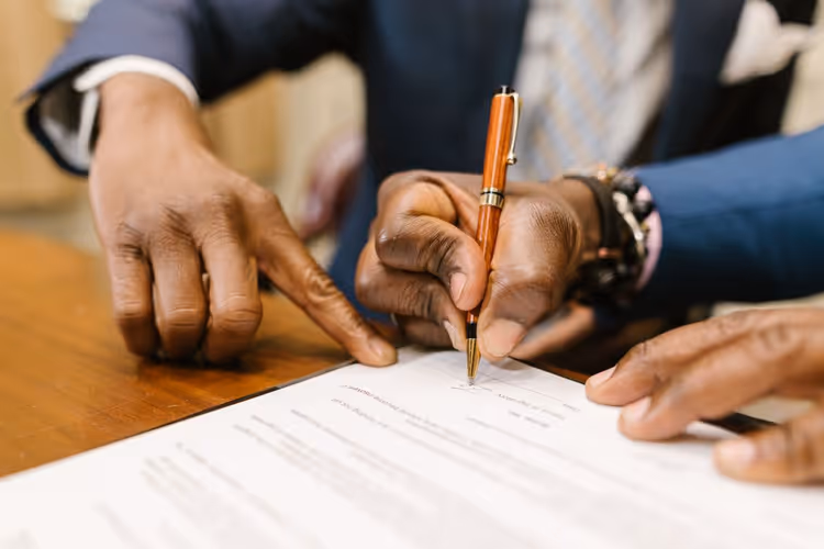 Discussing contract terms with a pen over a document
