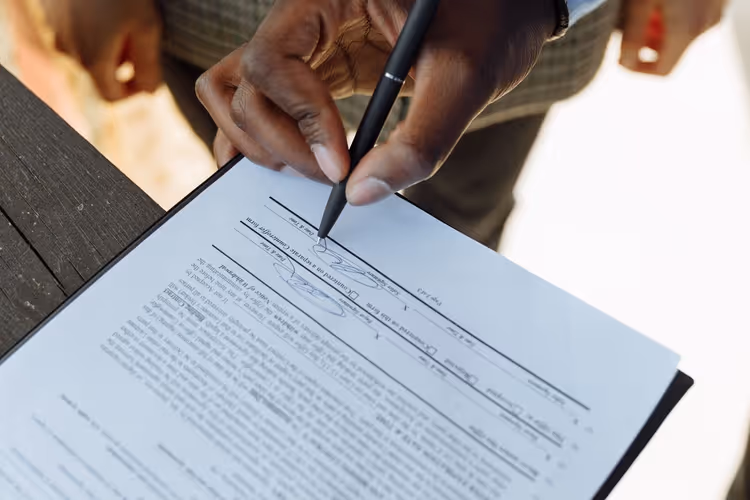 Signing a publishing contract at a desk
