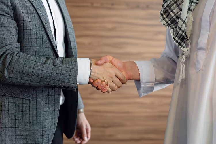 Two business people shaking hands after negotiations
